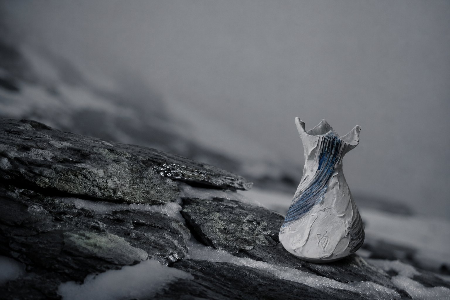 A Valdaire vessel against bare rock and snow light